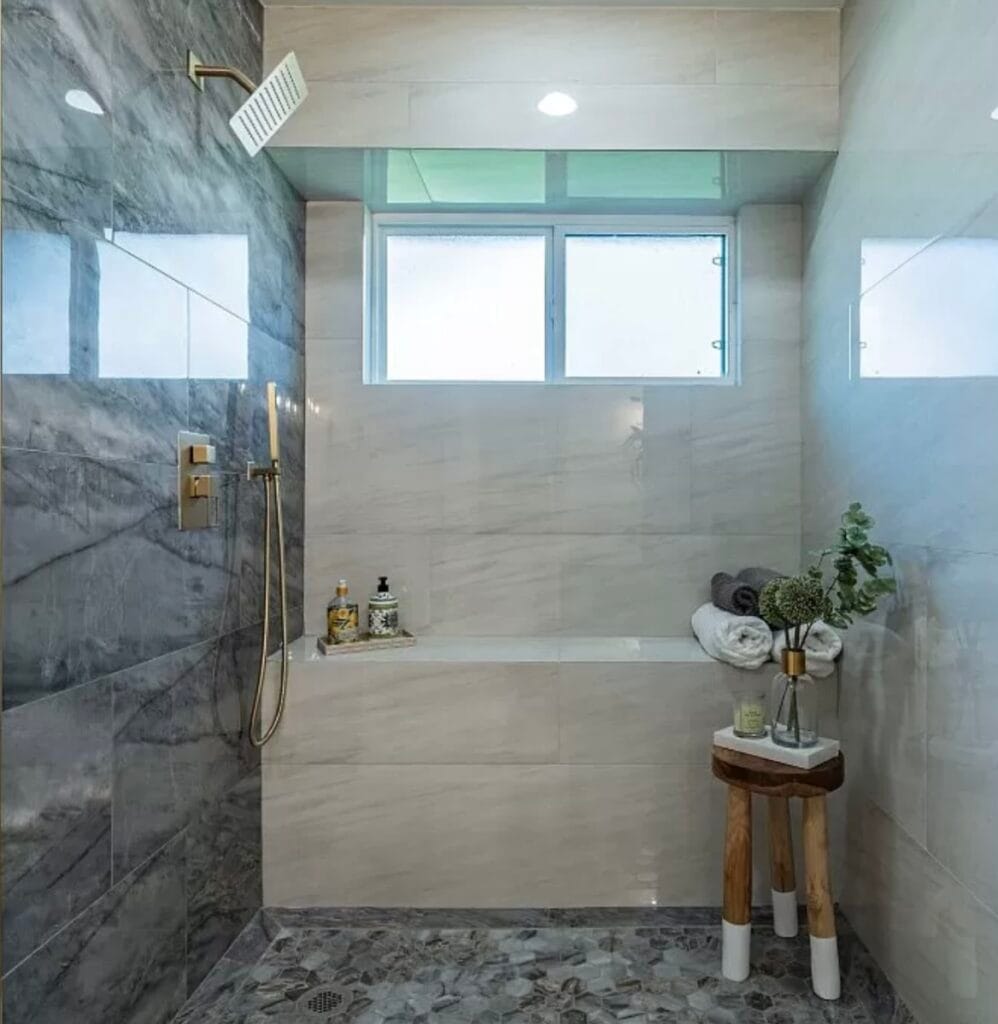 Ducha moderna renovada por BMI Design & Decor con azulejos de mármol y acabados elegantes en Texas.